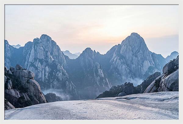 Granite Peaks Piercing Pale Sky
