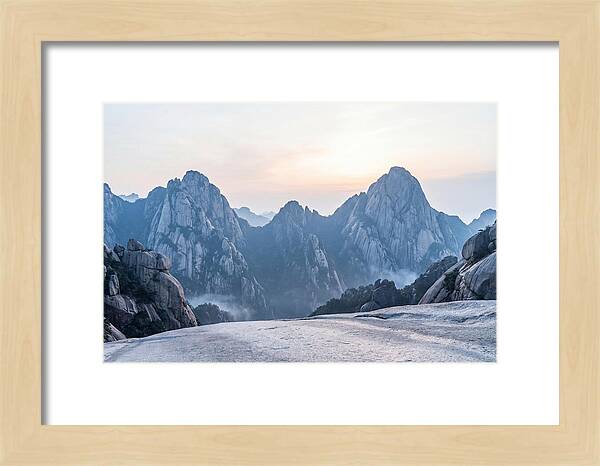 Granite Peaks Piercing Pale Sky