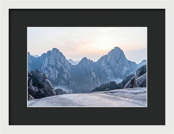 Granite Peaks Piercing Pale Sky