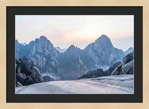Granite Peaks Piercing Pale Sky
