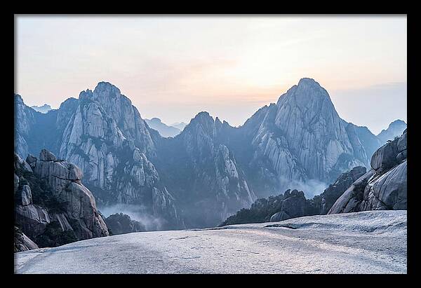 Granite Peaks Piercing Pale Sky