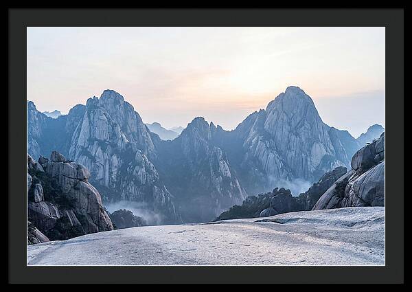 Granite Peaks Piercing Pale Sky