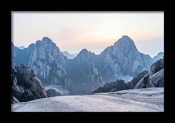 Granite Peaks Piercing Pale Sky