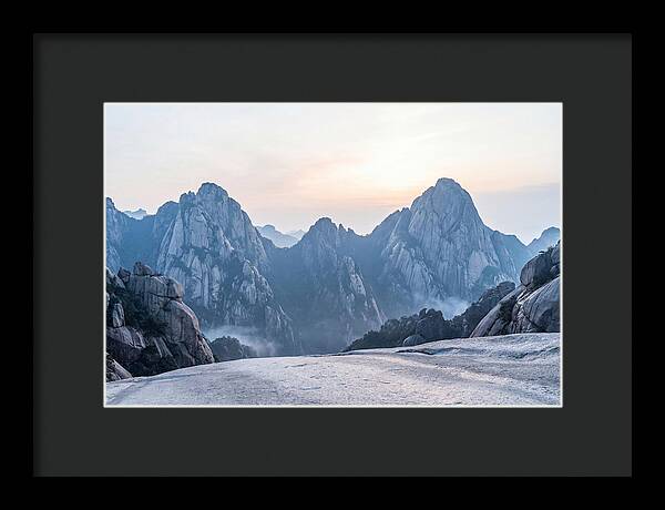 Granite Peaks Piercing Pale Sky