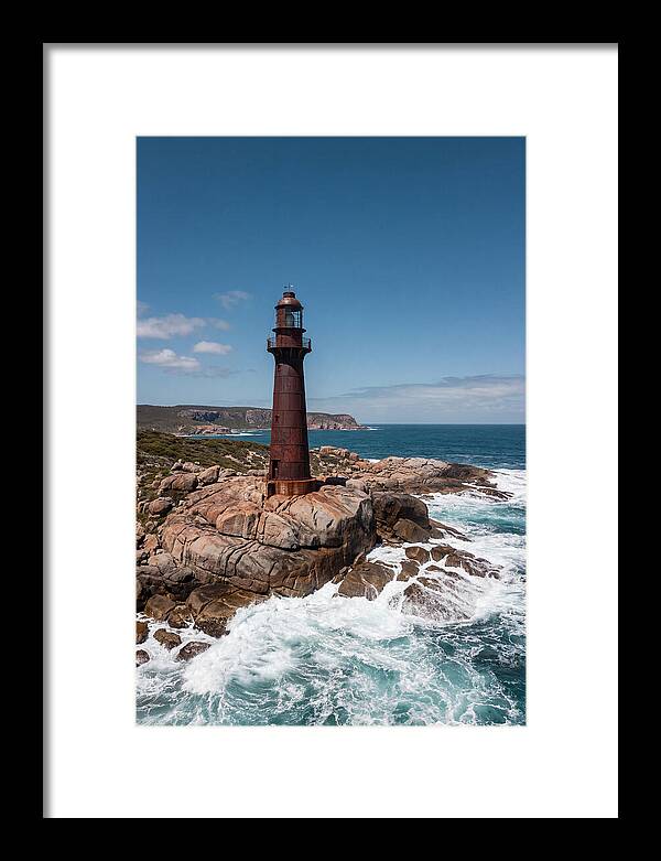 Historic Iron Lighthouse Against Waves