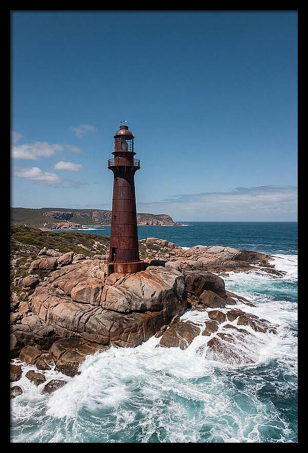 Historic Iron Lighthouse Against Waves