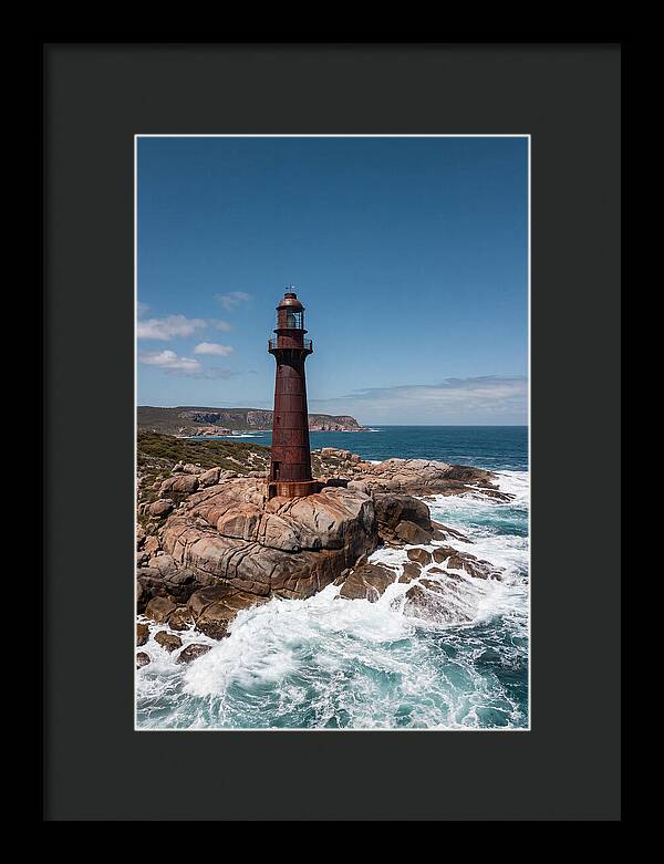 Historic Iron Lighthouse Against Waves