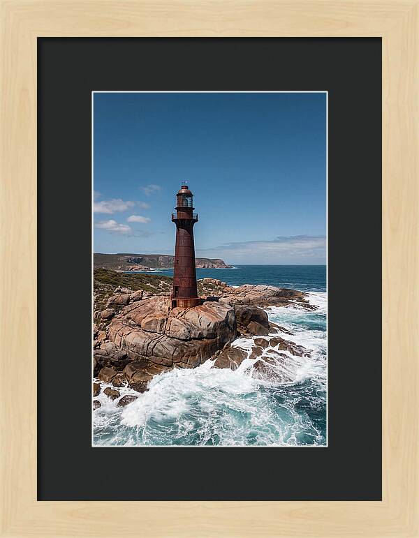 Historic Iron Lighthouse Against Waves
