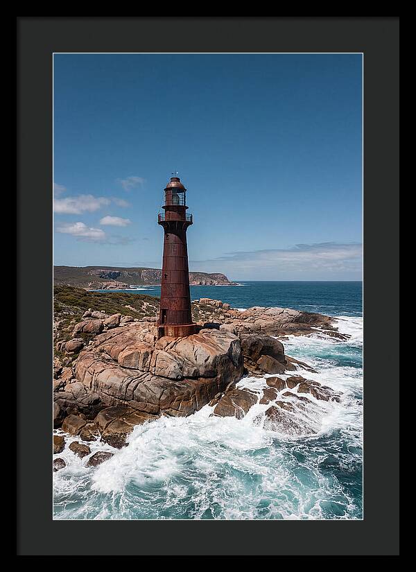 Historic Iron Lighthouse Against Waves