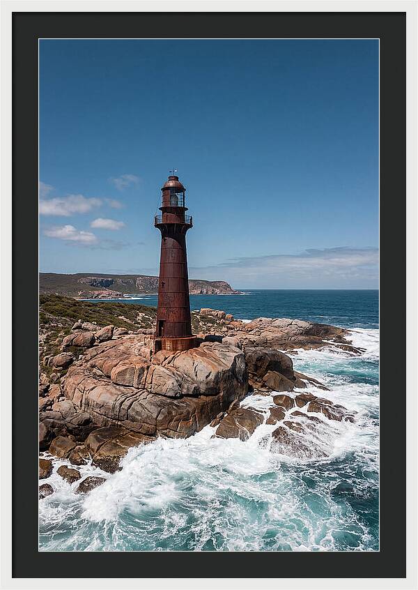 Historic Iron Lighthouse Against Waves
