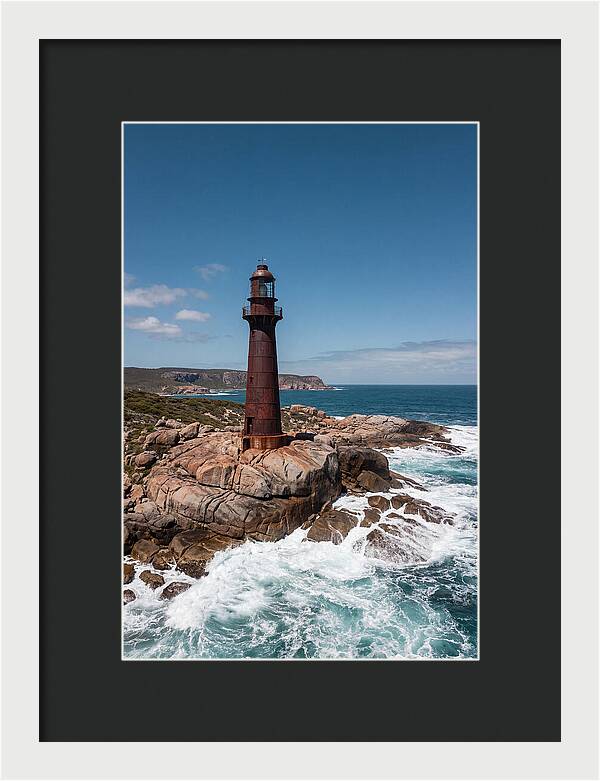 Historic Iron Lighthouse Against Waves