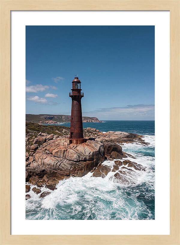 Historic Iron Lighthouse Against Waves