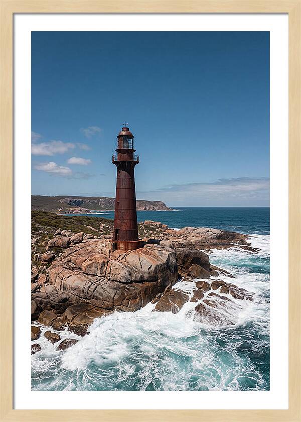 Historic Iron Lighthouse Against Waves