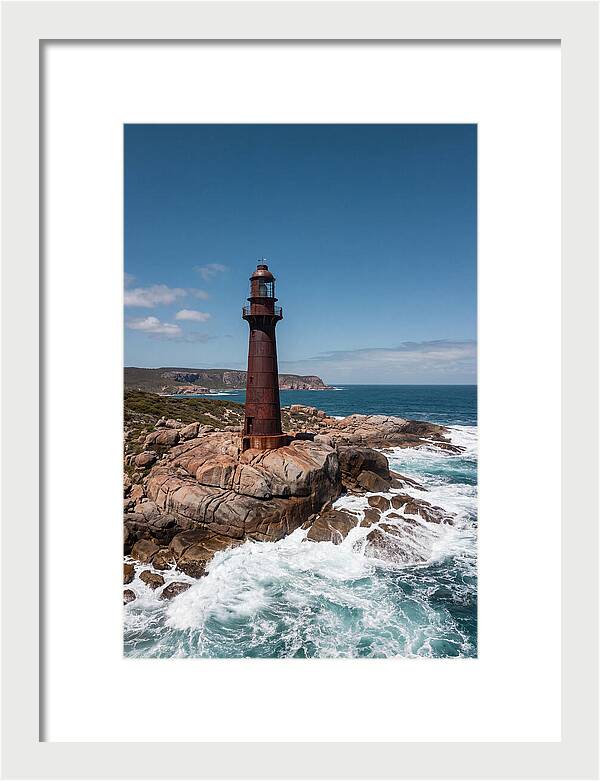 Historic Iron Lighthouse Against Waves