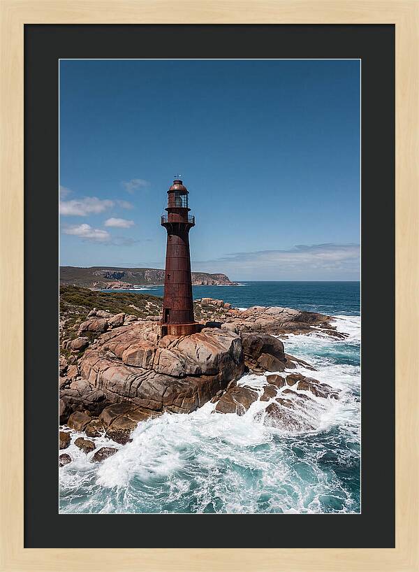 Historic Iron Lighthouse Against Waves