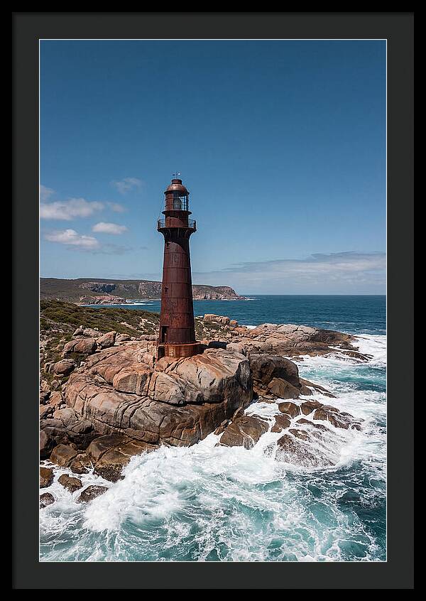 Historic Iron Lighthouse Against Waves