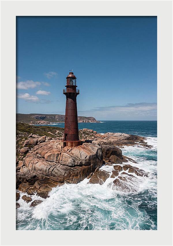 Historic Iron Lighthouse Against Waves