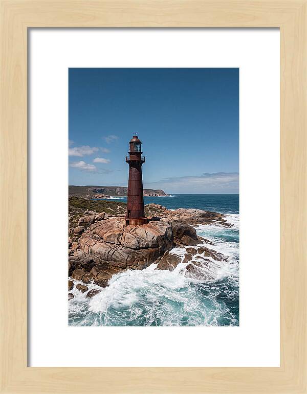 Historic Iron Lighthouse Against Waves