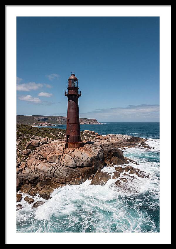 Historic Iron Lighthouse Against Waves