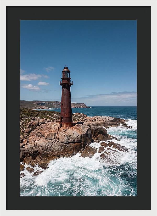 Historic Iron Lighthouse Against Waves