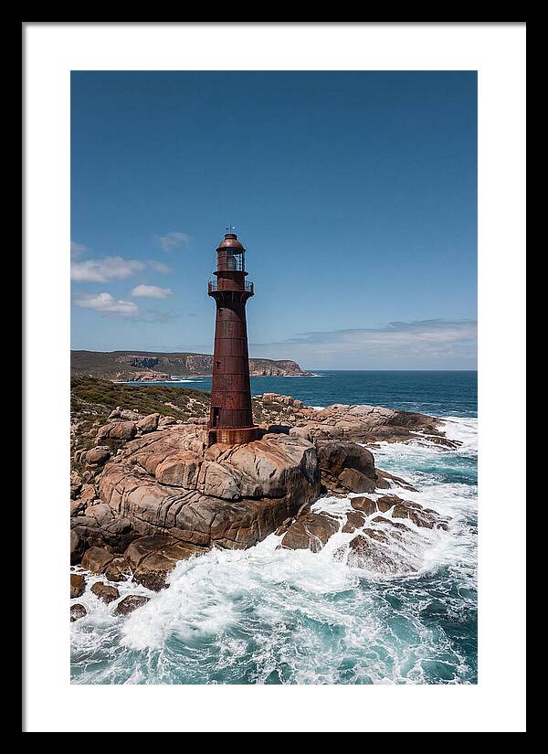 Historic Iron Lighthouse Against Waves