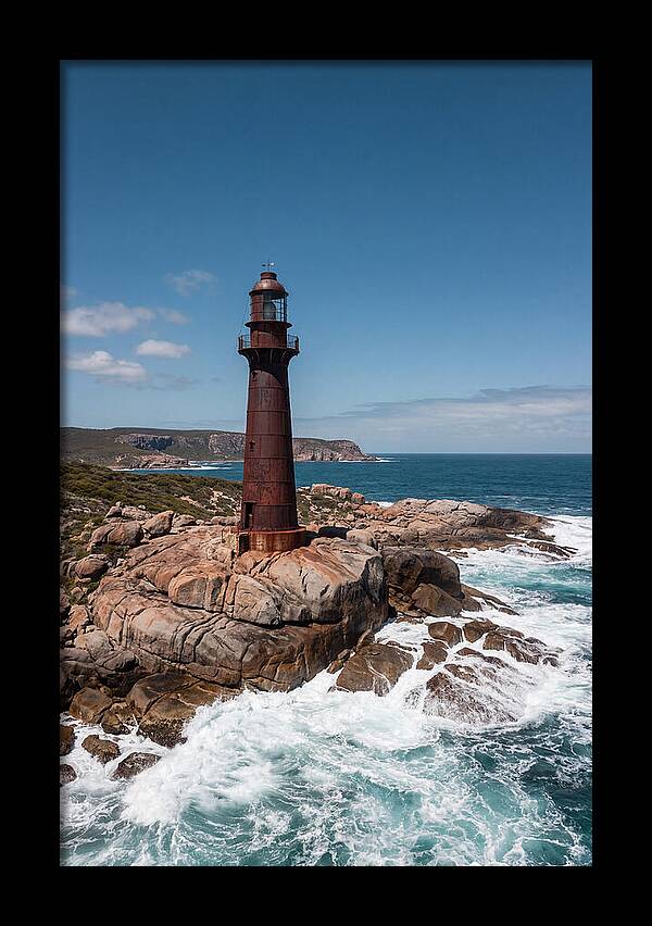 Historic Iron Lighthouse Against Waves
