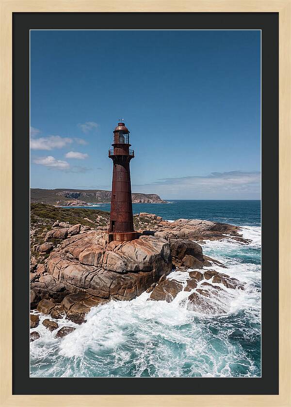 Historic Iron Lighthouse Against Waves