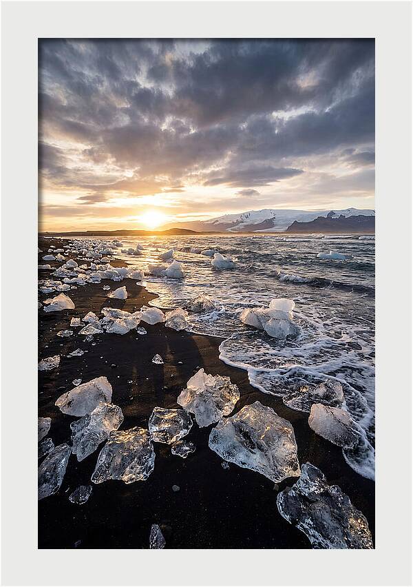 Icebergs At Sunset On Black Sand