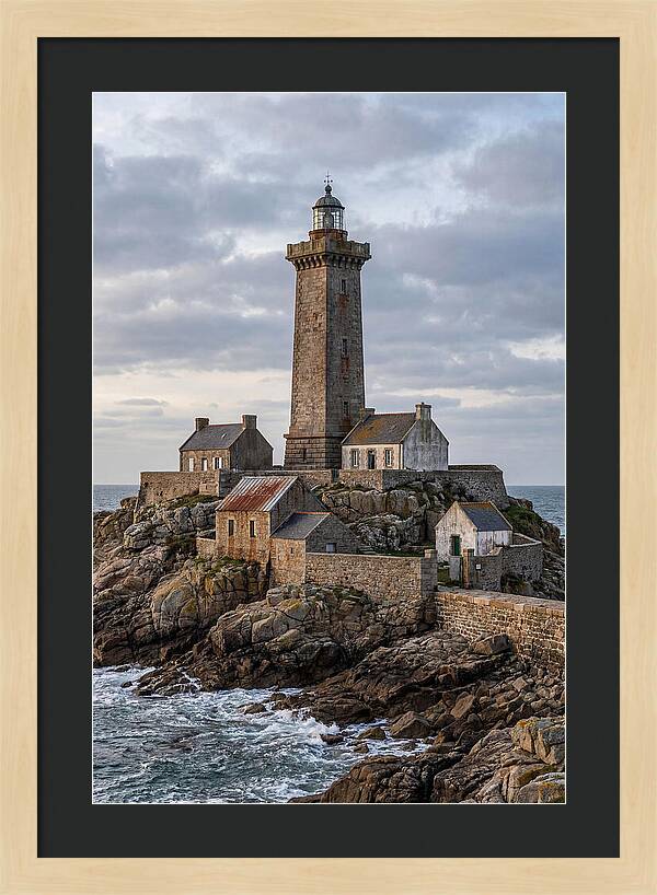 Lighthouse On Rocky Shoreline
