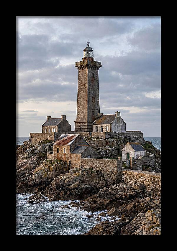 Lighthouse On Rocky Shoreline