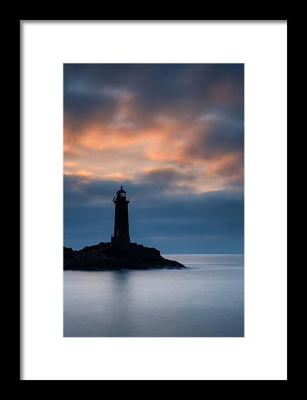 Lighthouse Silhouetted Against Dramatic Sky