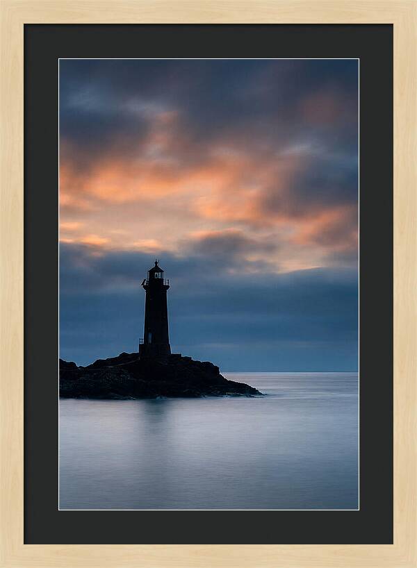 Lighthouse Silhouetted Against Dramatic Sky