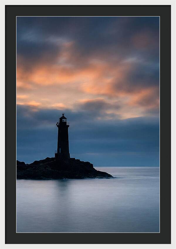 Lighthouse Silhouetted Against Dramatic Sky