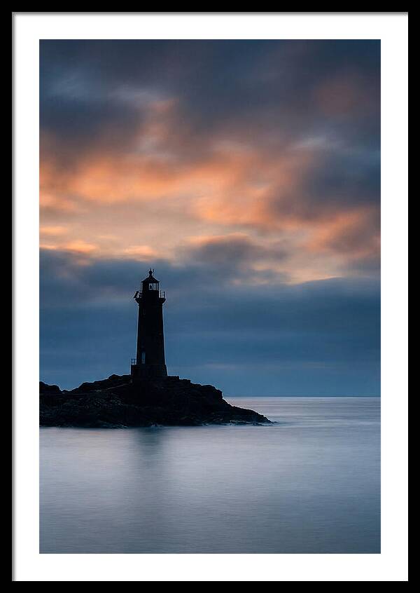 Lighthouse Silhouetted Against Dramatic Sky