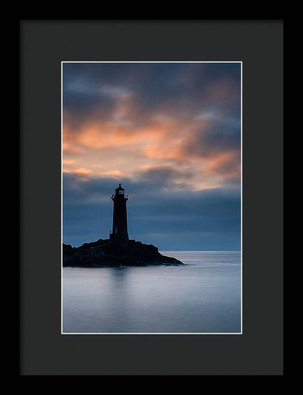 Lighthouse Silhouetted Against Dramatic Sky