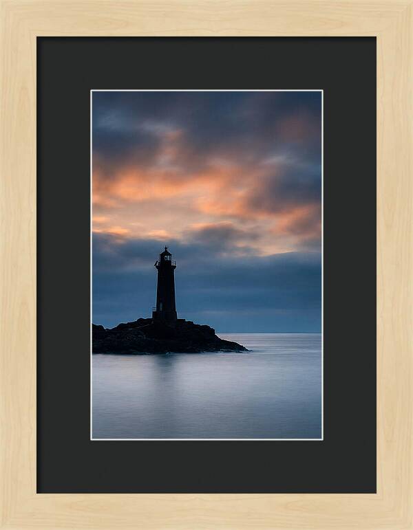 Lighthouse Silhouetted Against Dramatic Sky