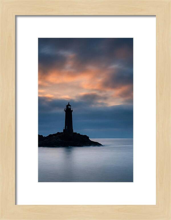 Lighthouse Silhouetted Against Dramatic Sky