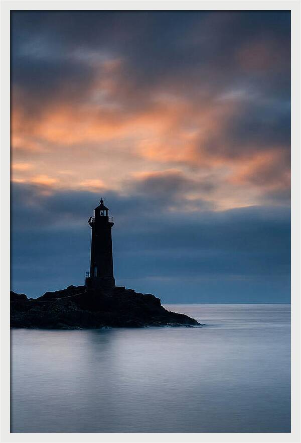 Lighthouse Silhouetted Against Dramatic Sky