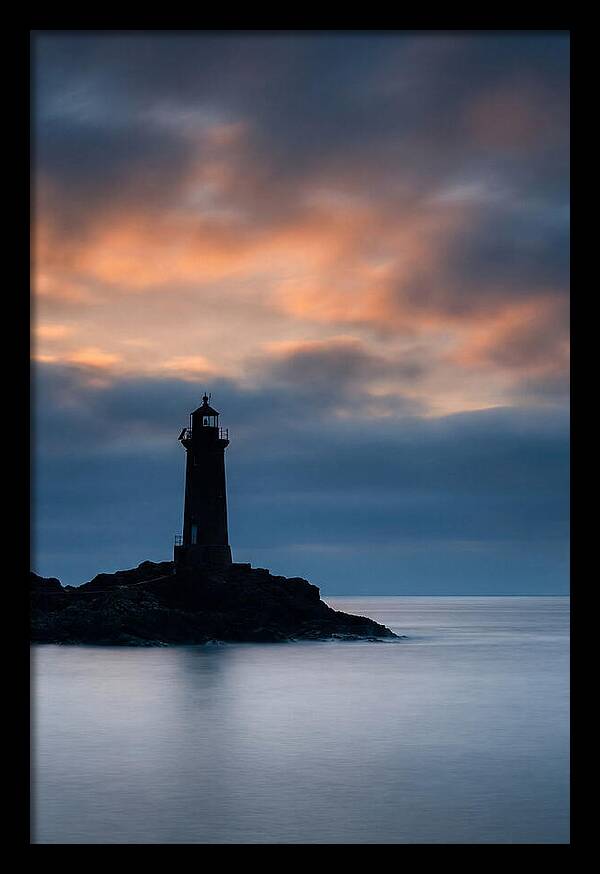 Lighthouse Silhouetted Against Dramatic Sky