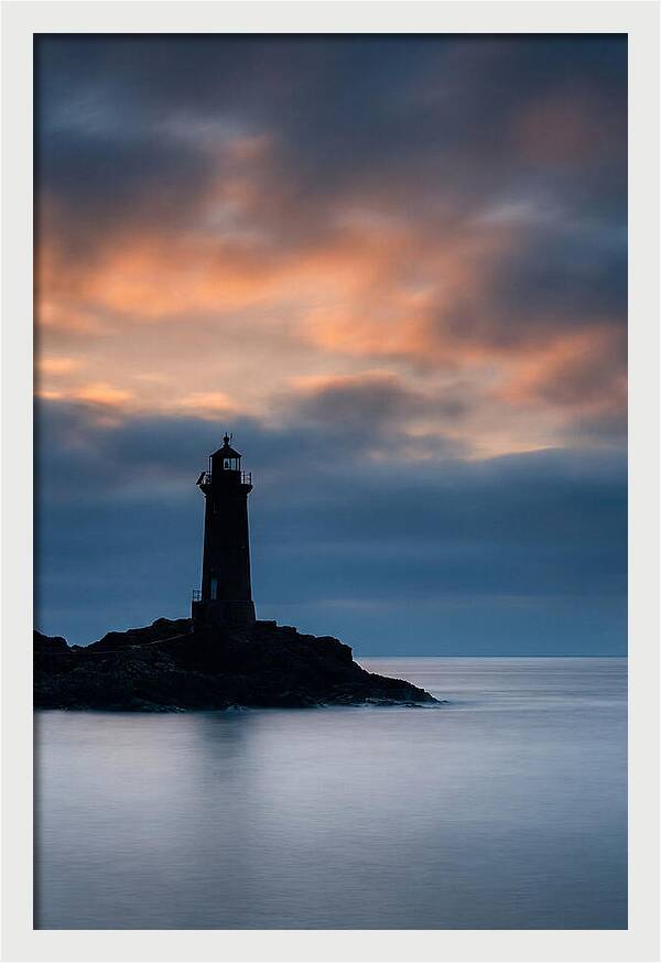 Lighthouse Silhouetted Against Dramatic Sky