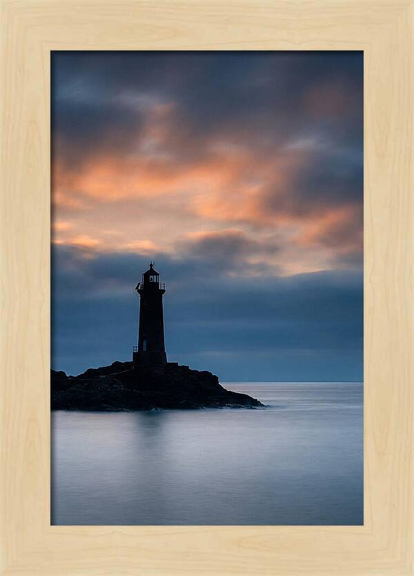 Lighthouse Silhouetted Against Dramatic Sky