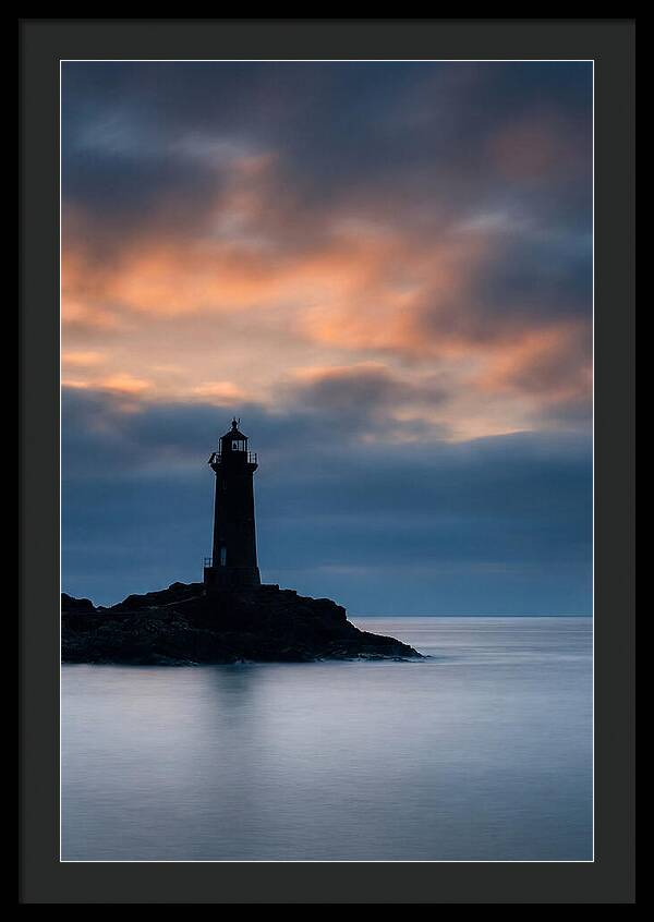 Lighthouse Silhouetted Against Dramatic Sky