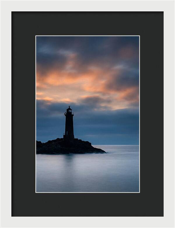 Lighthouse Silhouetted Against Dramatic Sky