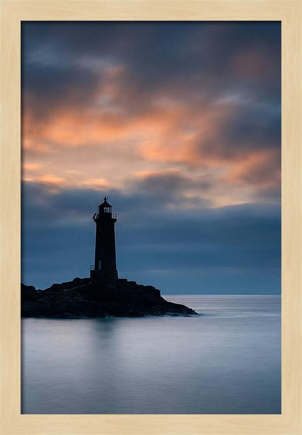 Lighthouse Silhouetted Against Dramatic Sky