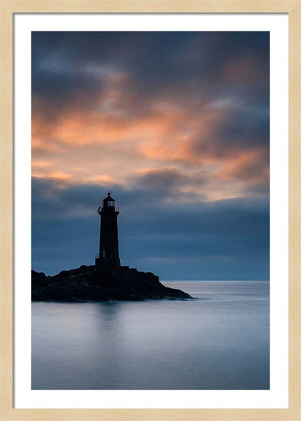 Lighthouse Silhouetted Against Dramatic Sky