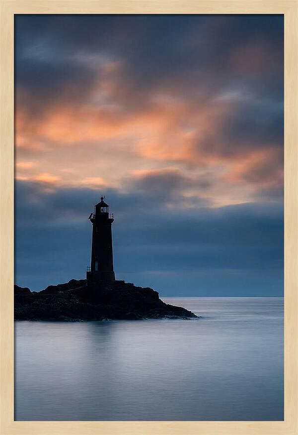 Lighthouse Silhouetted Against Dramatic Sky