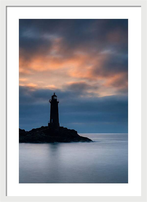 Lighthouse Silhouetted Against Dramatic Sky