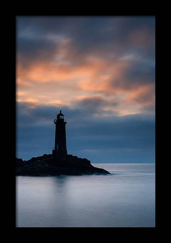 Lighthouse Silhouetted Against Dramatic Sky