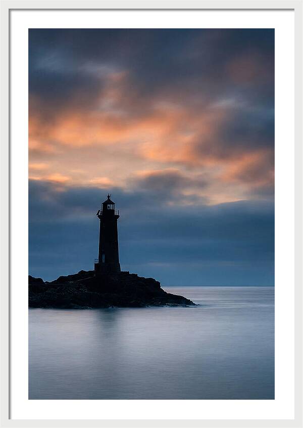 Lighthouse Silhouetted Against Dramatic Sky
