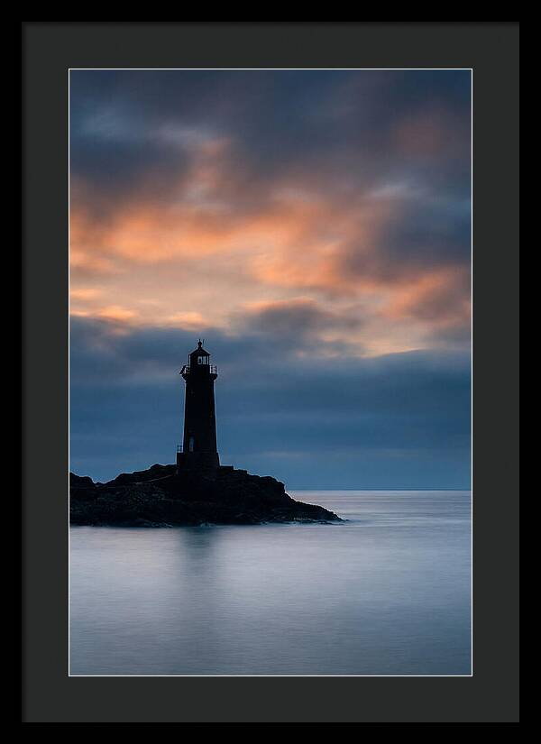 Lighthouse Silhouetted Against Dramatic Sky
